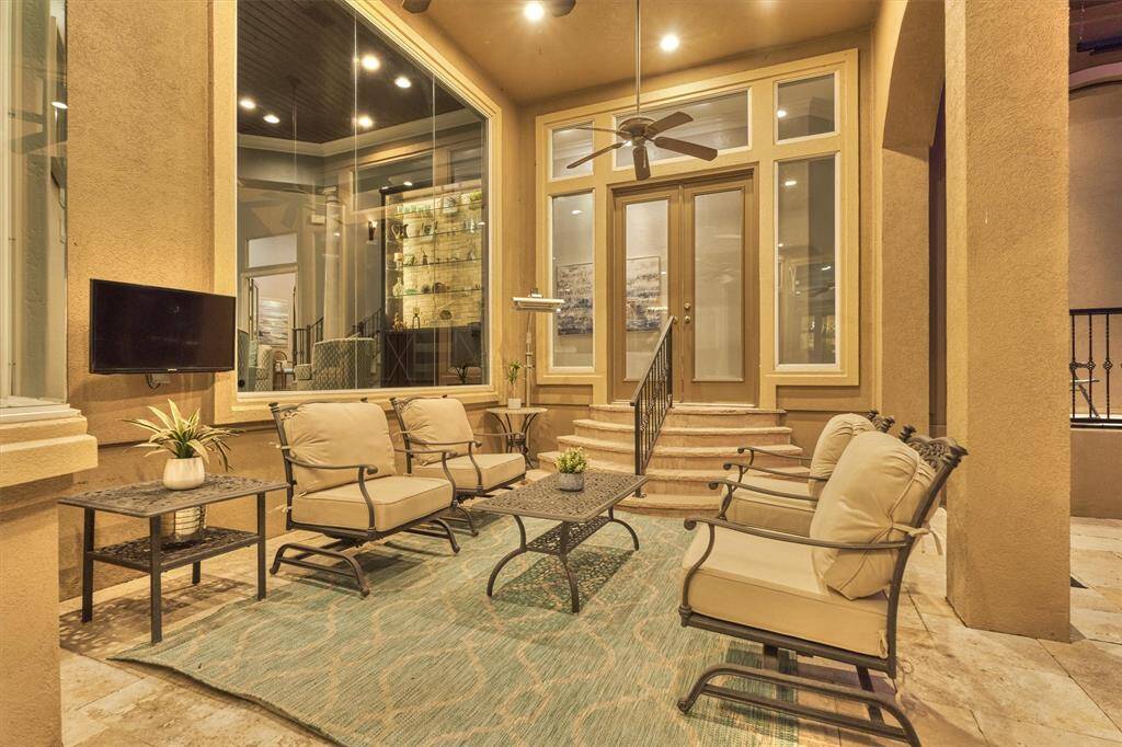 A cozy, covered back porch provides a serene space for enjoying the outdoor space.