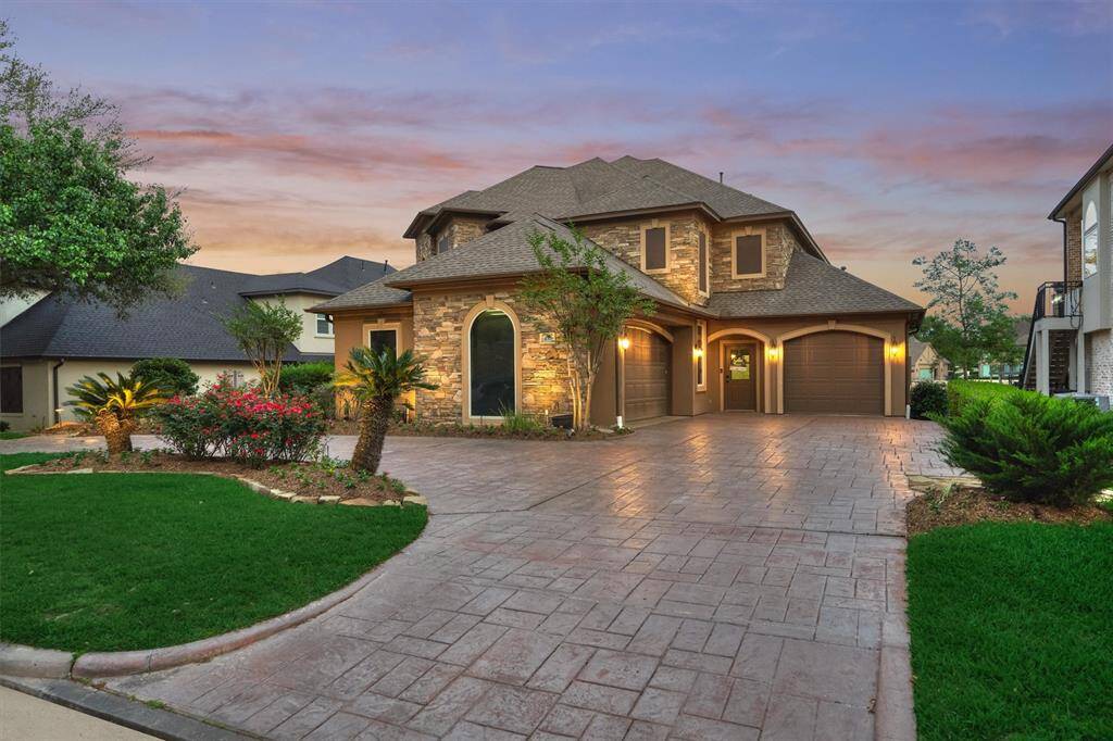 This property offers ample parking with a double-car garage, a single garage, and an extended driveway providing plenty of space for guests.