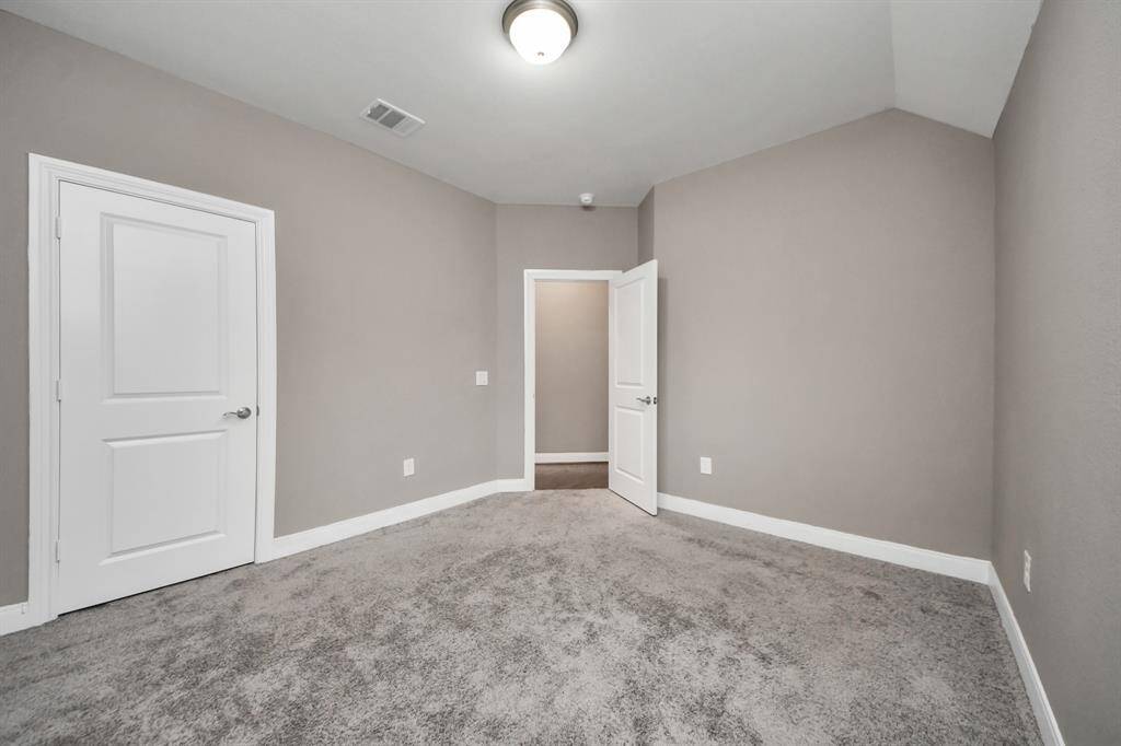 The guest bedroom retreat offers a warm and inviting space designed for comfort and relaxation. Featuring soft, neutral tones and plush carpeting, this serene haven provides a cozy atmosphere for visitors.