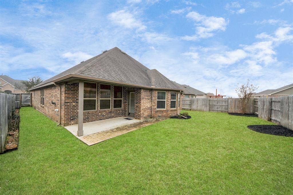 Enjoy the covered patio with an extended paver area and beautifully landscaped backyard, perfect for outdoor relaxation and entertaining.