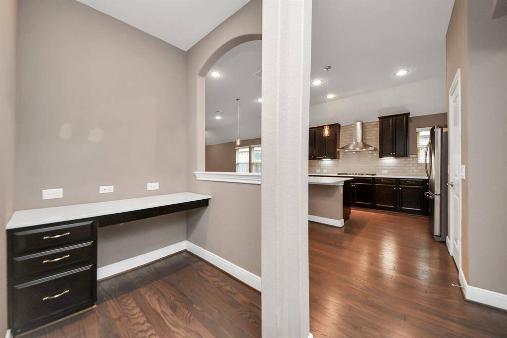 Just off the kitchen, a convenient computer nook with a built-in desk provides the perfect space for homework, remote work, or daily organization.