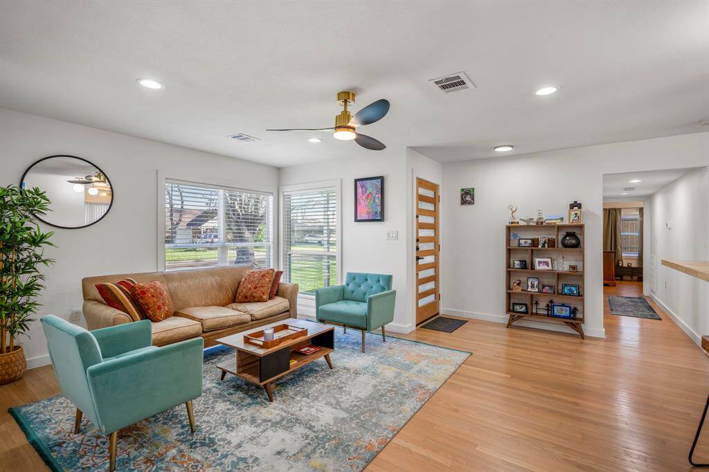 This living space is large enough for a sectional and other Texas-sized pieces of furniture. The hallway leads to a full bathroom and two secondary bedrooms.