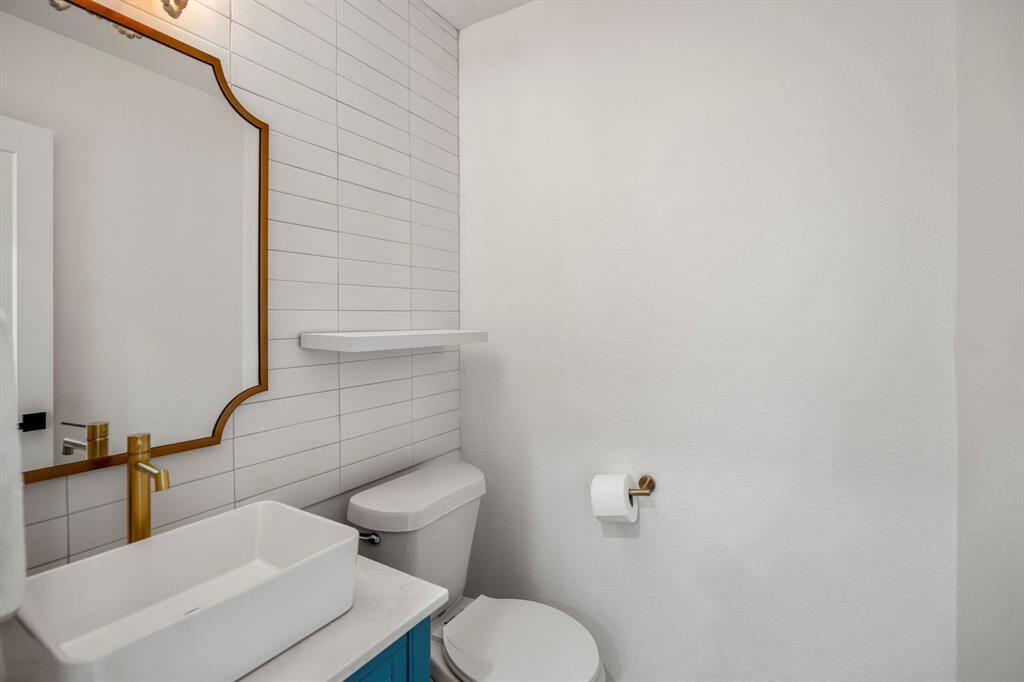 Adorable powder bath with beautiful subway tiles all the way to the ceiling.