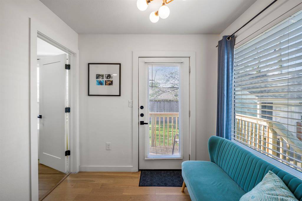 A sitting area with a large window is perfect for a reading nook. This door takes you out to the private deck.