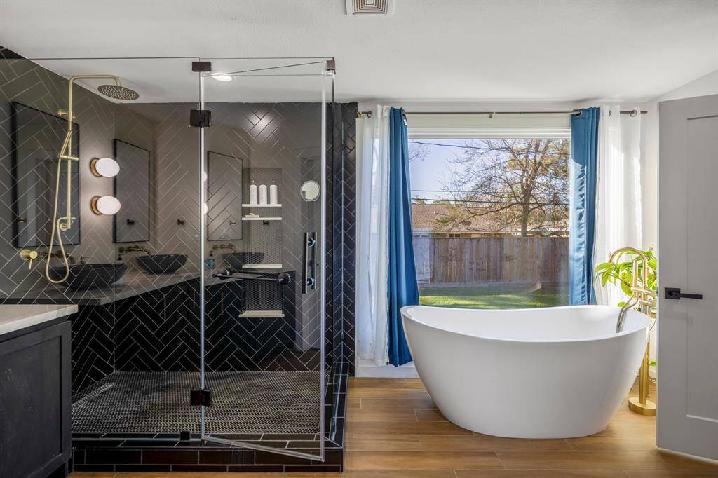 An incredible stand-up shower welcomes you with a rainfall shower head and a separate handheld wand.