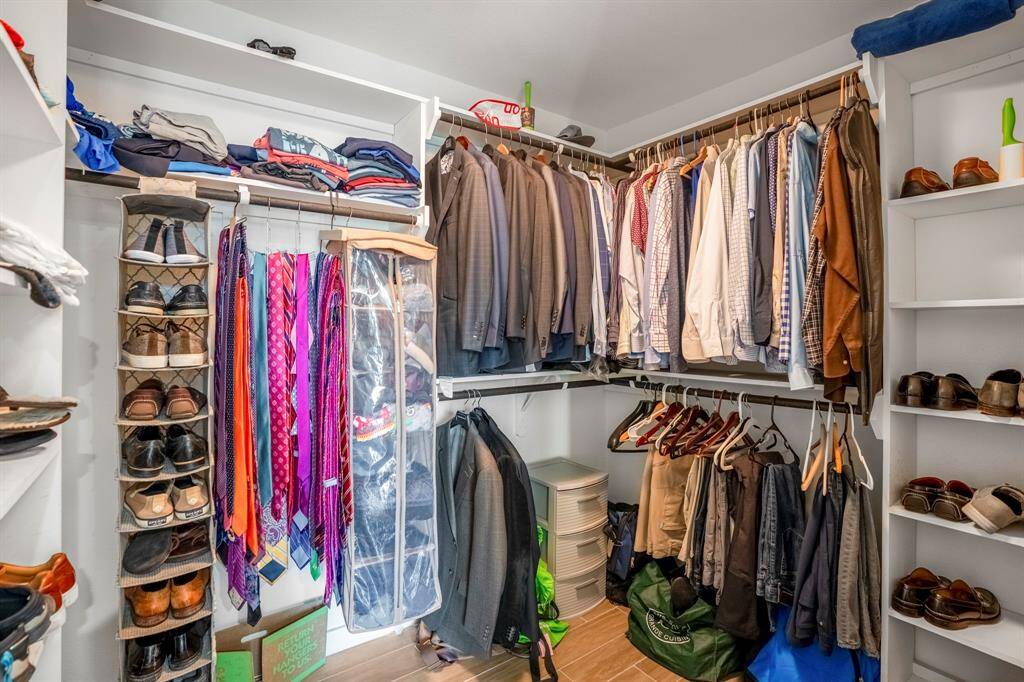 Large primary walk-in closet with built-in storage shelves.