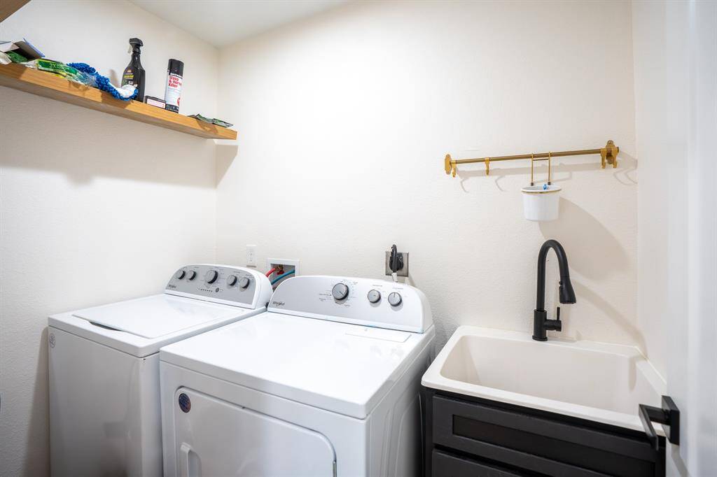 Utility room with a sink and storage space.