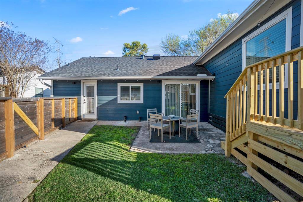 Welcome to this adorable backyard space where sliding glass doors open up to outdoor seating.