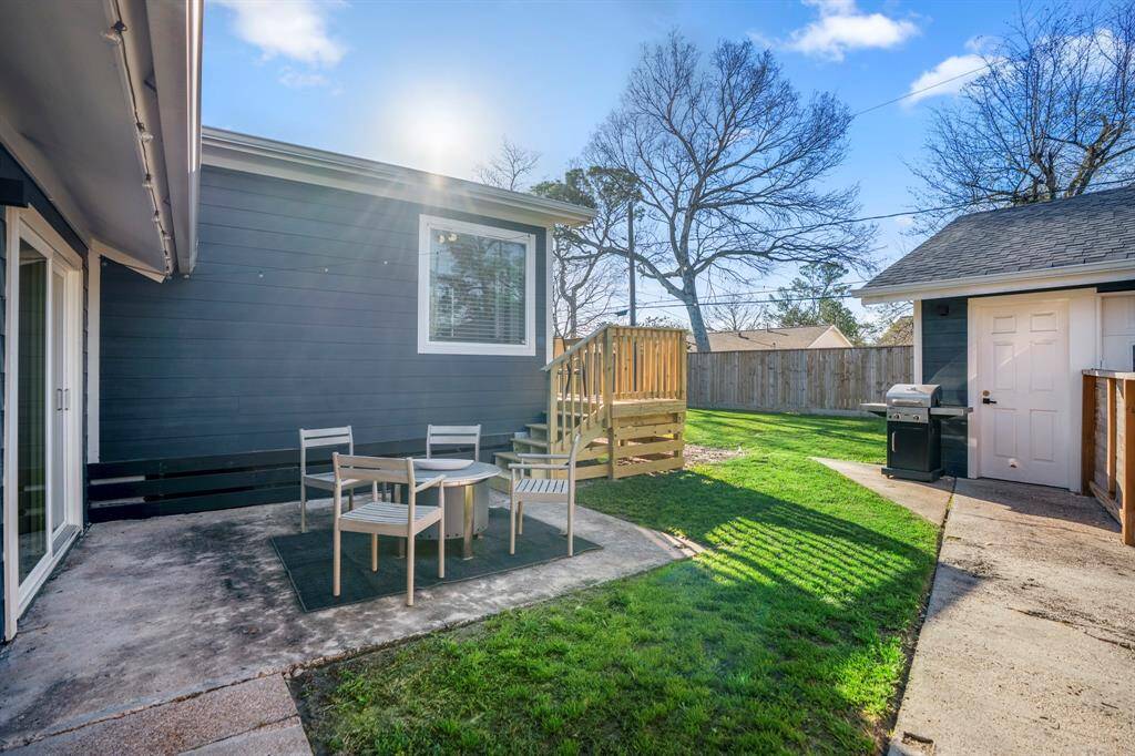 String lights along the back of this home allow for beautiful nights enjoying the weather on this backyard patio.
