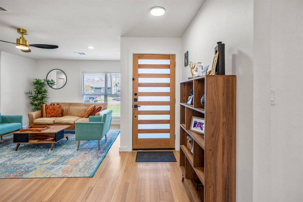 Reverse view of the entry with the living room located just to the right of the front door. Large windows allow for ample natural light.