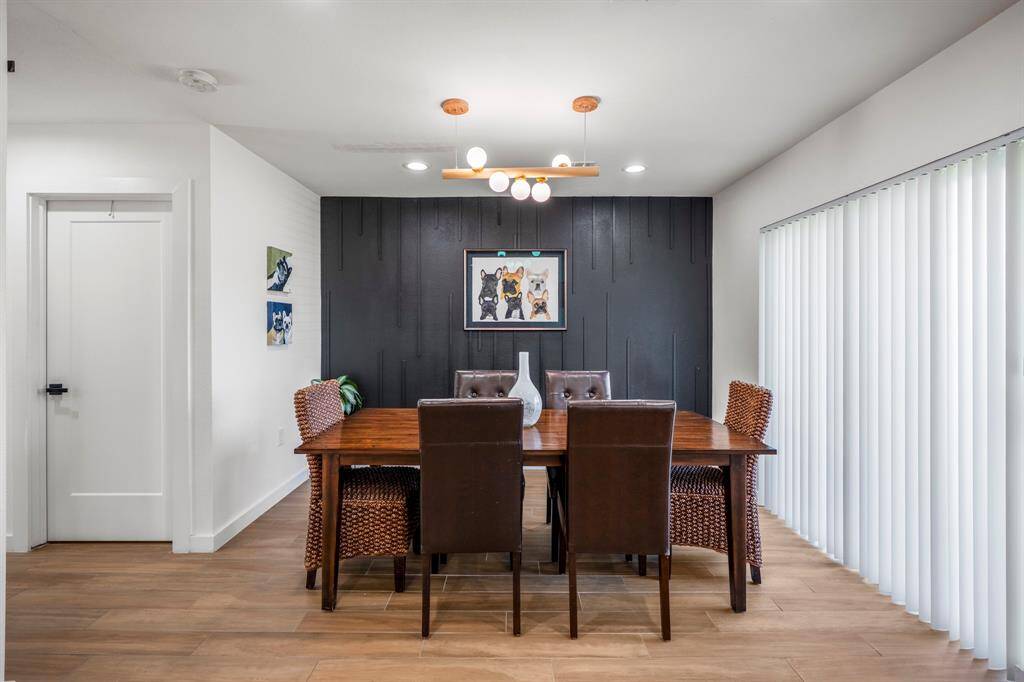 Custom wood wall accents this space well. Sliding glass doors lead to a front patio where you can enjoy your morning coffee.