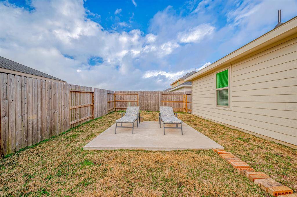 The open patio provides a sturdy, level surface for outdoor enjoyment. A low-maintenance space with plenty of potential, it’s a perfect spot for morning coffee, potted plants, or evening gatherings. Its size is just right for a small outdoor setup—whether for a café-style table, a grill station, or a pair of lounge chairs.