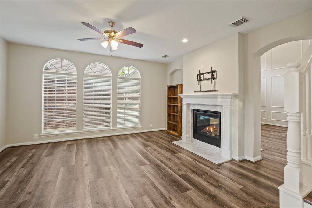The other side of the fireplace bodes a den. This space has multi use! You can use it as a sitting room or as your everyday living room lounging area. Being so close to the kitchen, its perfect for additional entertaining space!
