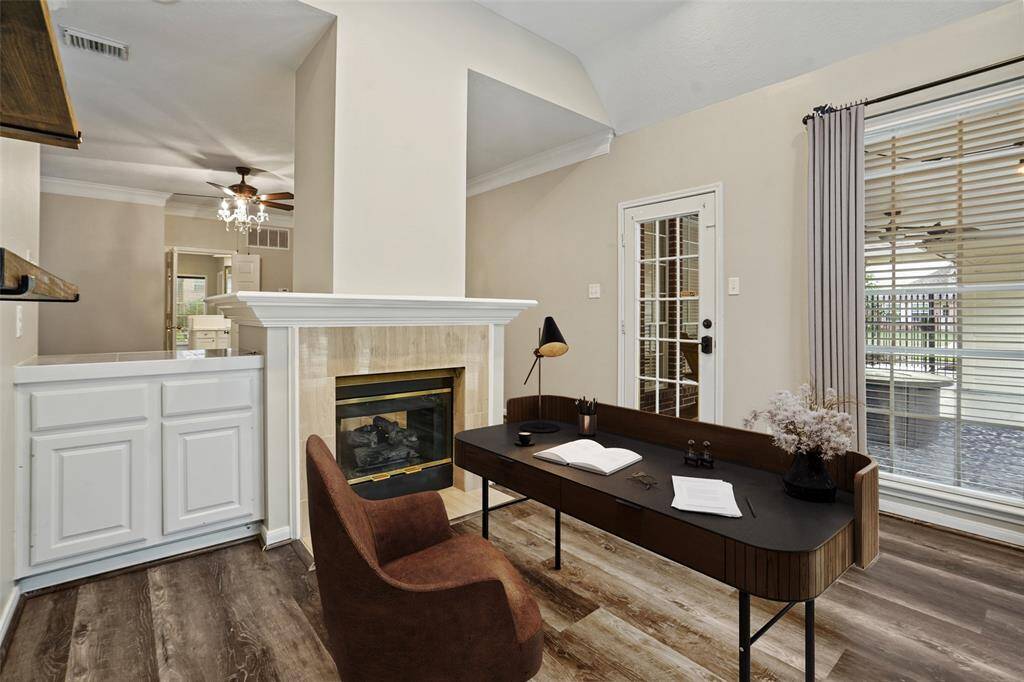 A virtually staged office area off of the master bedroom. Sitting next to the fireplace and also able to look outside the beautiful backyard.