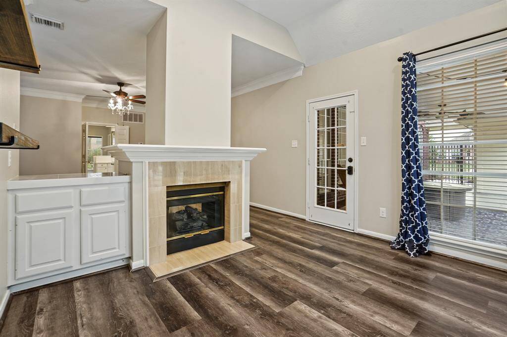 The other side of the fireplace is an office/study or could be used as a quiet sitting space that looks out to the beautiful pool and landscaping in the backyard.