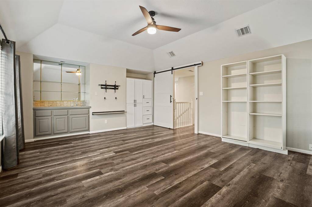 This amazing game room is upstairs and secluded to limit the overflow of noise to the downstairs. This room has a working wet bar and custom cabinetry was added for storage