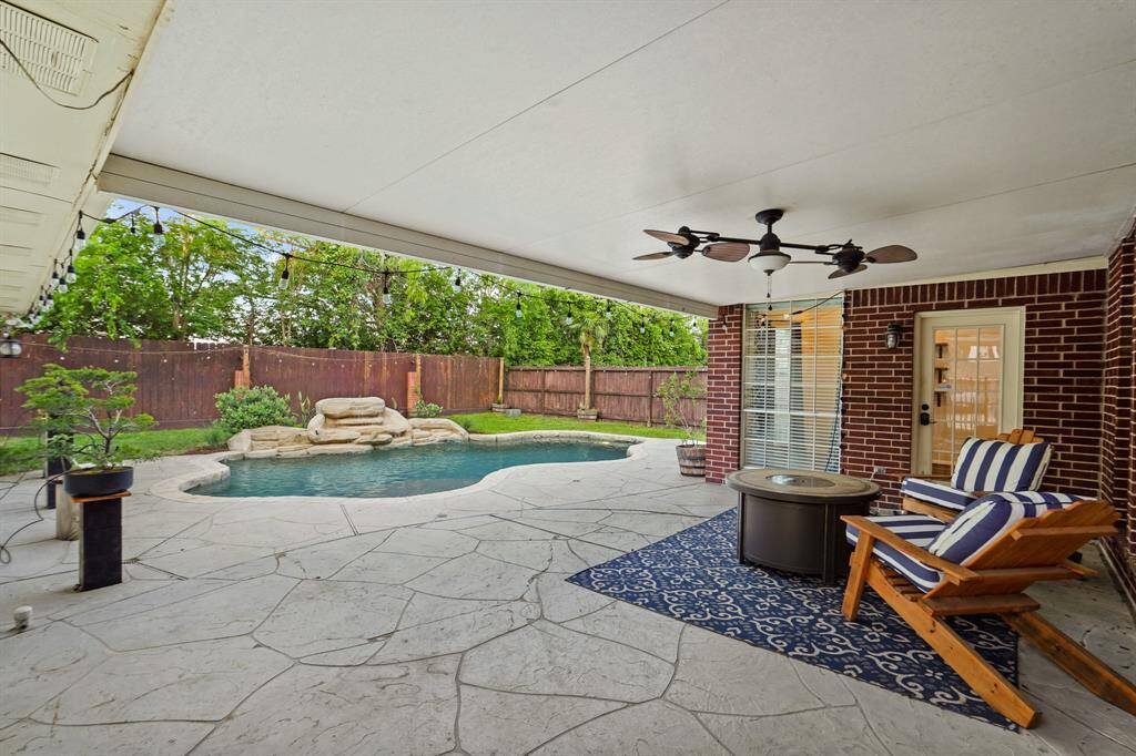 This beautiful backyard has a great covered patio that overlooks the pool.