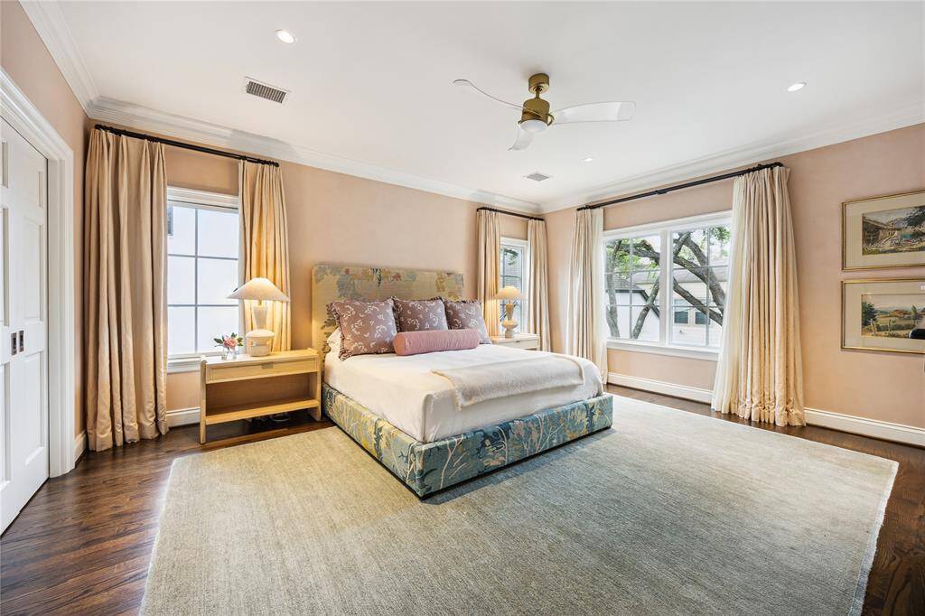 This serene Primary Bedroom boasts a soft and elegant touch with a lime wash from Portola Paints and abundant natural light streaming through large windows. Two-layer custom drapes on each window.