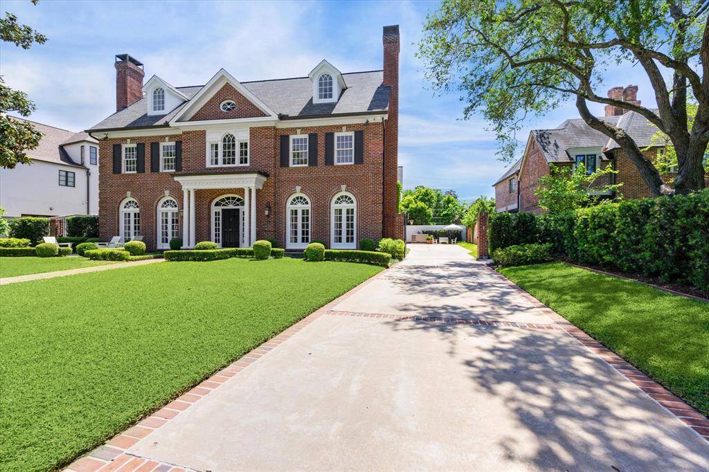 Another view of the front facade. With the automatic gate open, you see the wide driveway all the way down to the whole home generator.