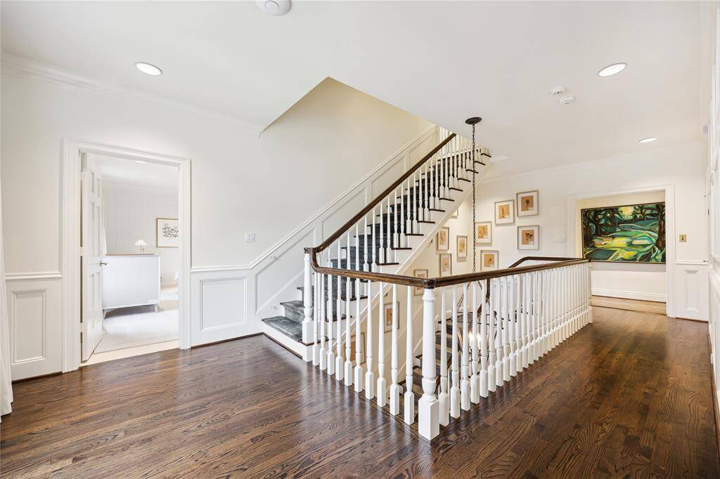 This bright and elegant upstairs Landing features rich hardwood floors, wide hallways, and open staircase leading to the Third Floor.