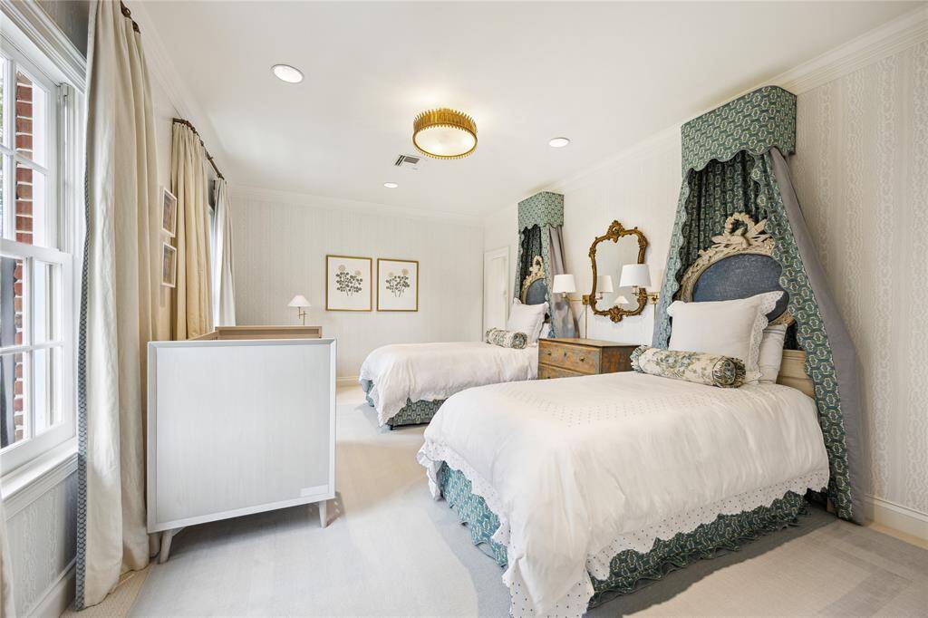 This room includes Schumacher Moire wallpaper carried into the bathroom as well as custom drapes.