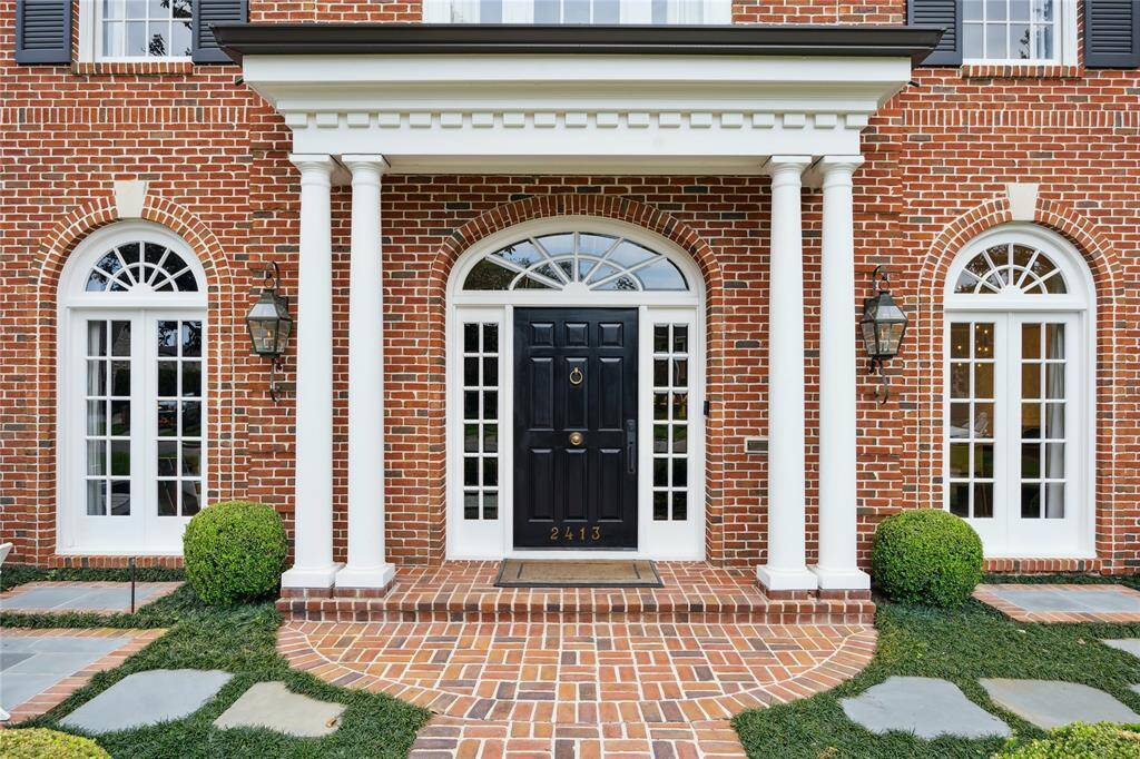 Stately entrance to this lovely traditional River Oaks property
