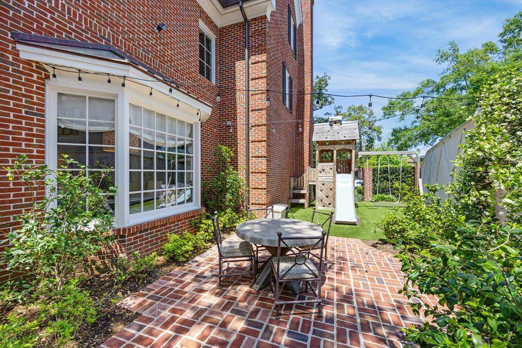 This spacious side yard allows for an additional seating area as well as a sizable playscape.