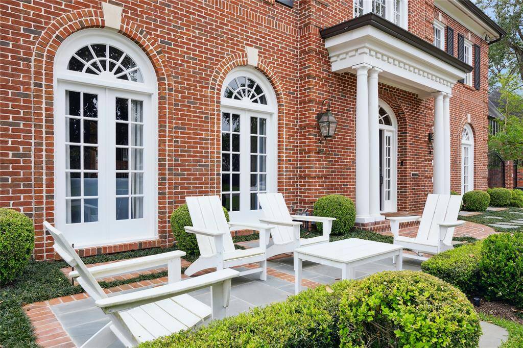 Charming seating area in the front yard. The perfect spot to catch up with neighbors and enjoy the beautiful front yard and mature Magnolia tree.