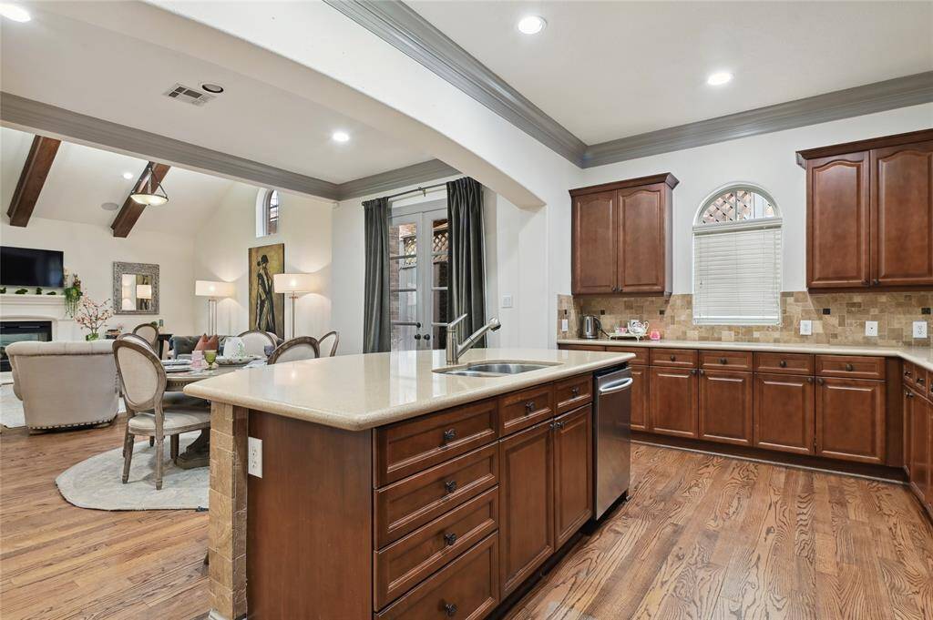 Grand chefs' kitchen overlooks the elegant living space and outdoor area!
