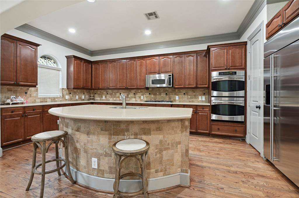 Spacious kitchen is equipped with large island, stainless steal appliances and granite counters!