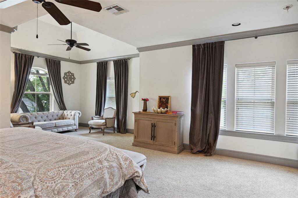 Spacious primary bedroom overlooks the private front lawn!