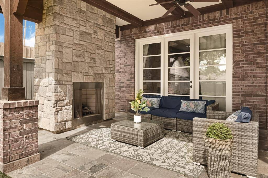 Gorgeous outdoor covered veranda is equipped with fireplace and extra seating area!