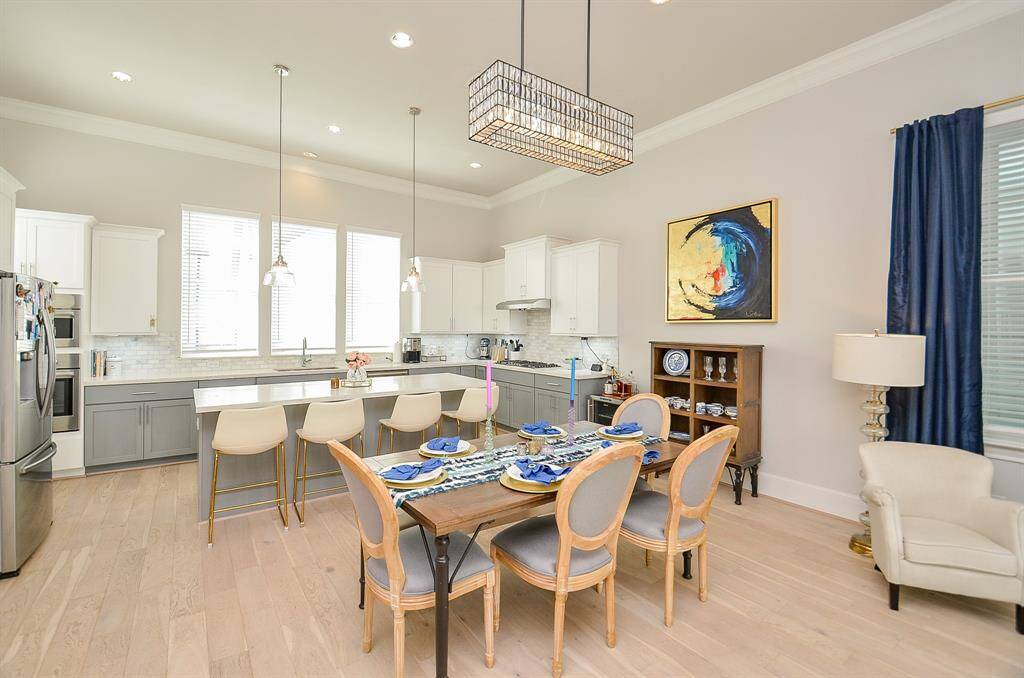 Tons of natural light with desirable large kitchen, light colored wood plank flooring throughout home.