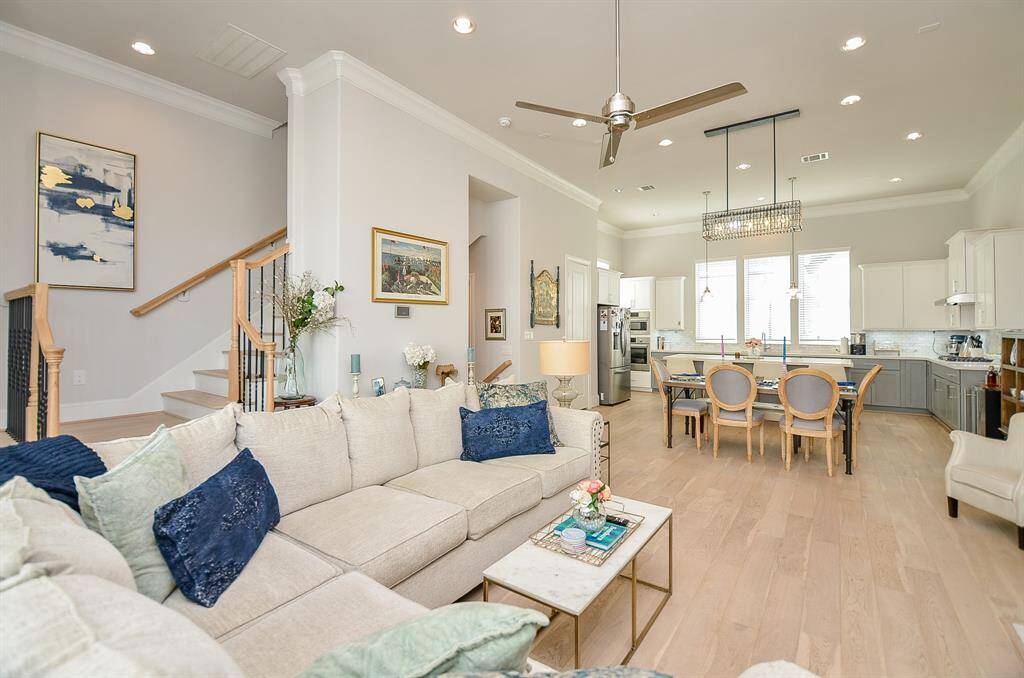 Desirable open floor plan that is light and bright. High ceilings, wood stairs leading to the 3rd floor. This home is barely lived in - a little over a year old but has custom features, window coverings and window treatments, ceiling fans, chandelier, refrigerator and washer/dryer.