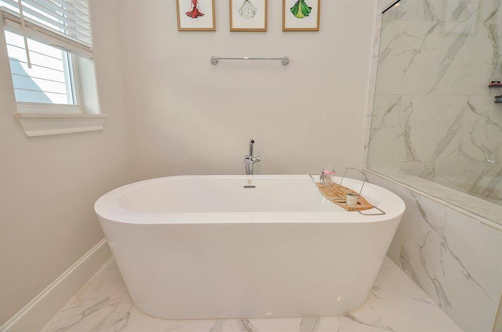 Come relax in your standalone bathtub in this elegant primary bathroom.
