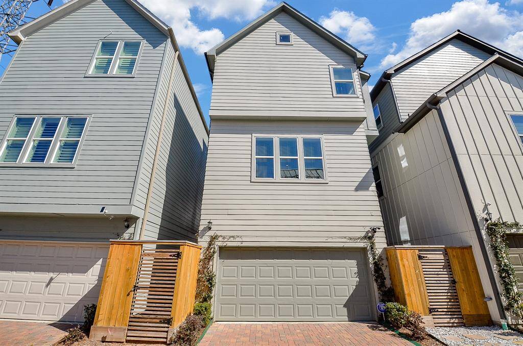 The rear of the home has a two-car garage and side access gate. Desirable paved driveway adds to the appeal.