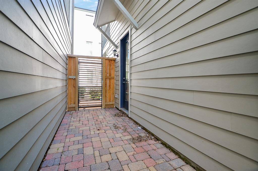 Gated and bricked side yard.