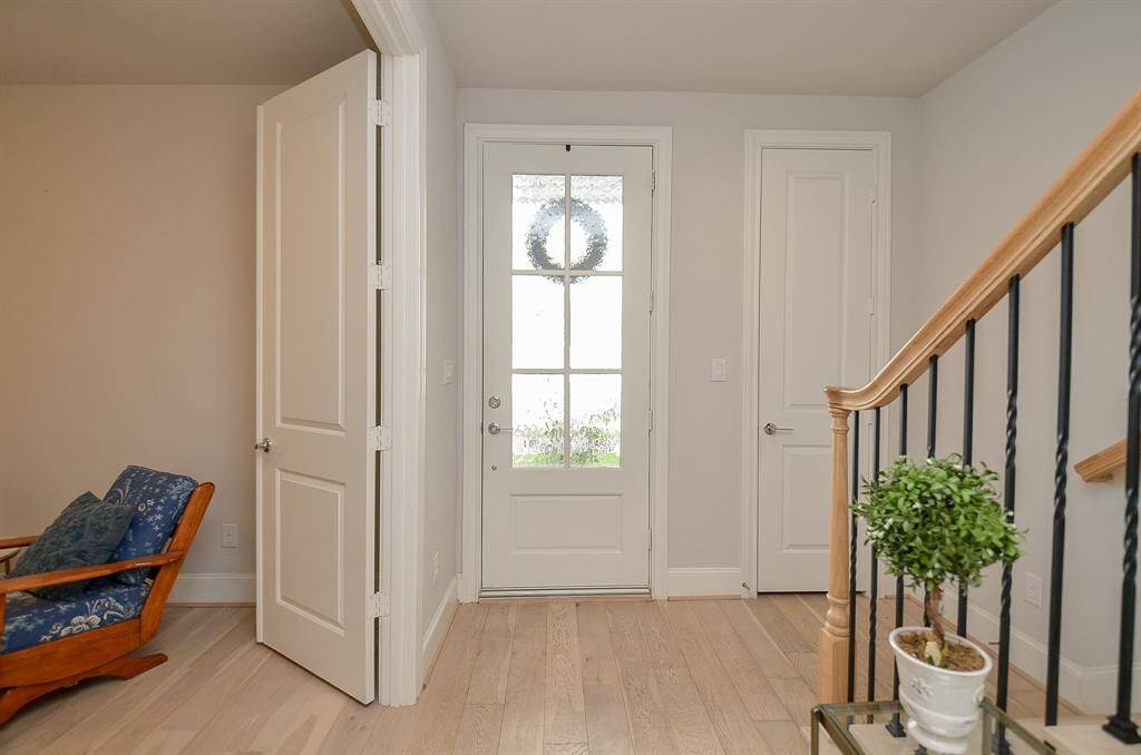 Entrance with light colored wide wood plank flooring.