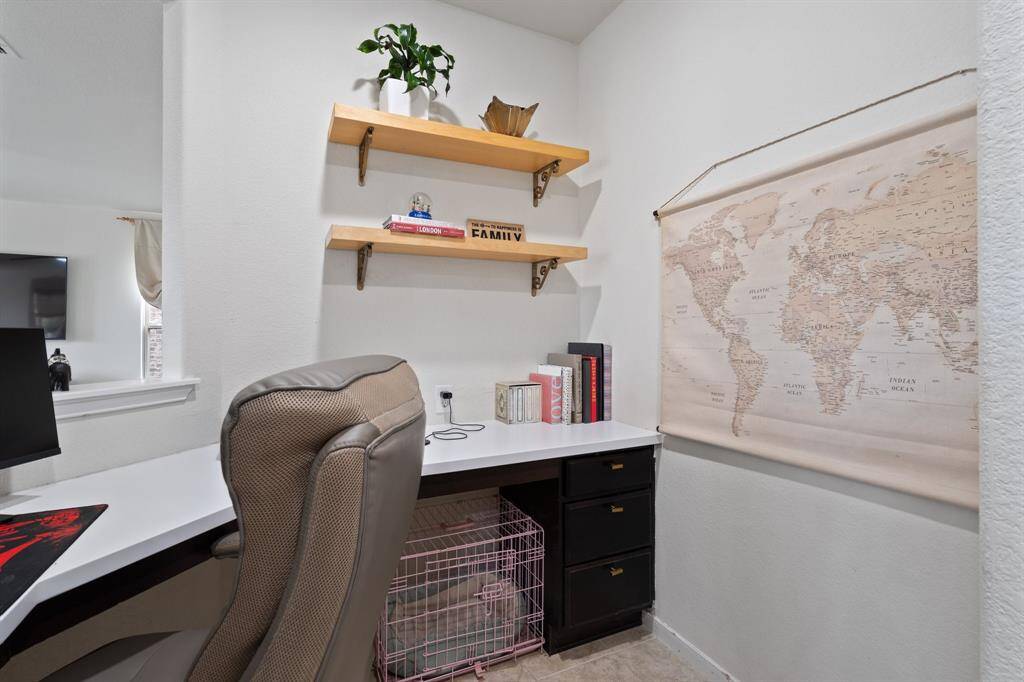 Additional office space is located off the living room and has a built-in desk!
