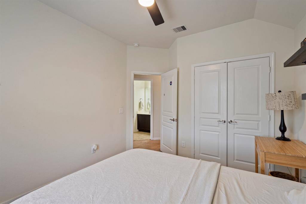 Secondary bedroom features awindow and plush carpet.