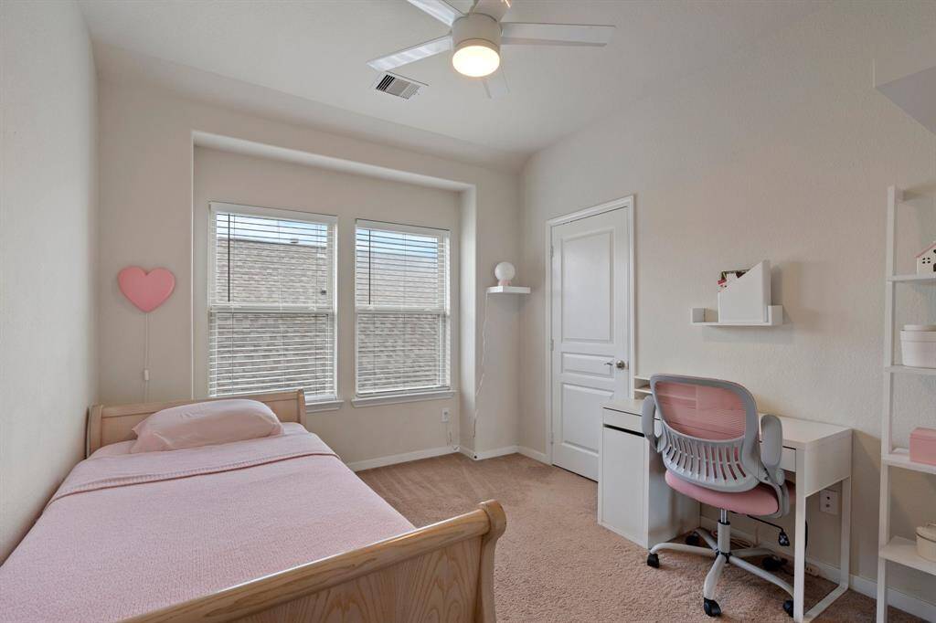 Third bedroom features largewindows and plush carpet.