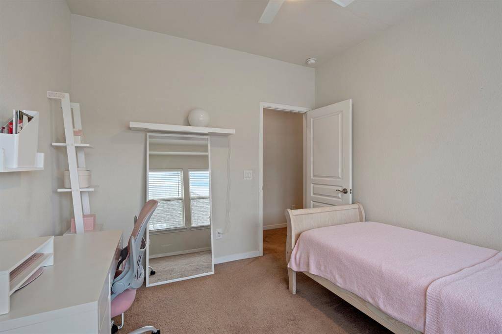 Third bedroom features largewindows and plush carpet.