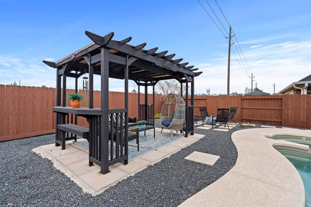 The backyard pergola overlooks the pool.