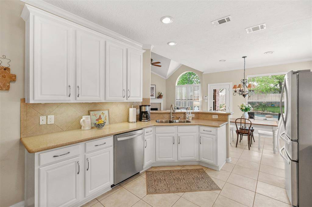 Open to the breakfast and family room, the kitchen allows for views of the beautiful backyard.