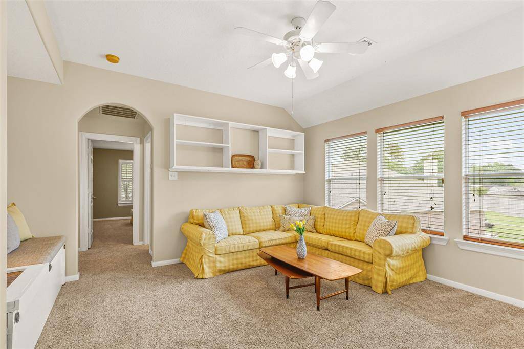 Upstairs gameroom with built-in shelving and storage bench.
