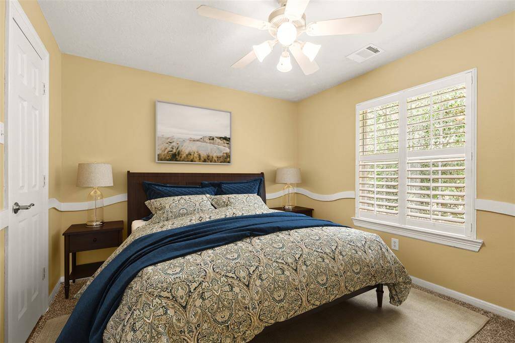 Upstairs bedroom with fresh paint and plantation shutters. Photo virtually staged.