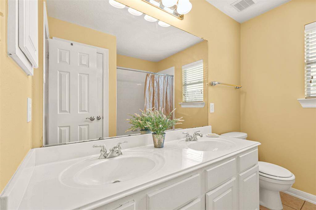 Upstairs bathroom with double sinks.