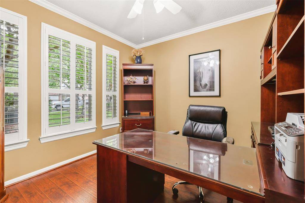 Study with French doors, plantation shutters and crown moulding offer privacy for a home office.
