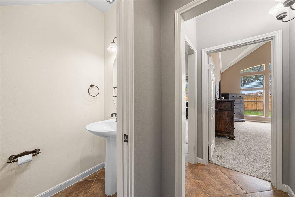 A well-appointed half bathroom is conveniently located on the main level, ideal for guests and everyday living. Adjacent to the half bath, the utility room offers added practicality, completing this functional and thoughtfully designed space.