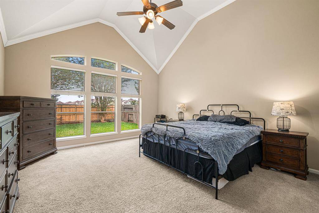 This expansive owner's retreat located on the first floor, features soaring ceilings and three sun-filled windows framing serene backyard views. The elegant ensuite bath offers dual vanities, a freestanding soaking tub, and a spacious walk-in shower, while the generously sized walk-in closet completes this private sanctuary.